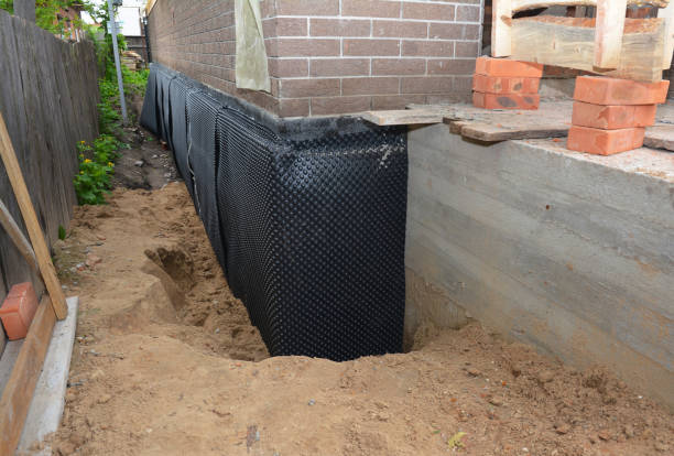 Happy homeowners after waterproofing job in Warrior